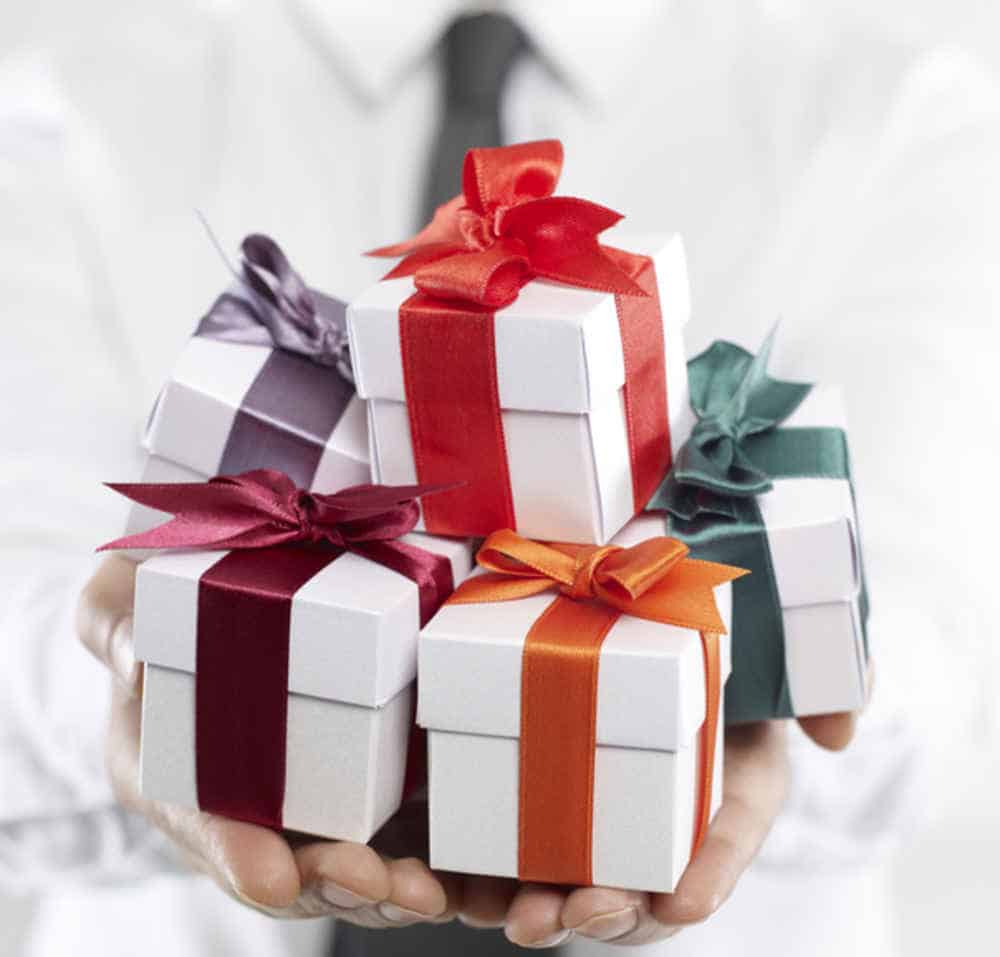 Businessman holding gift boxes.