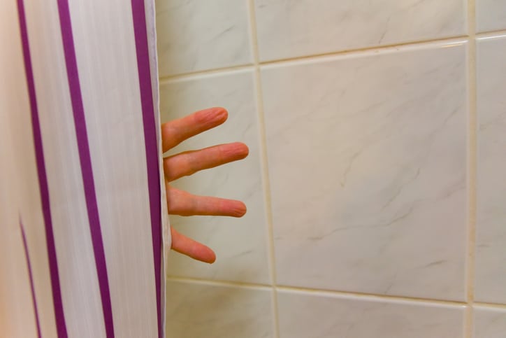 pruney fingers pulling back shower curtain